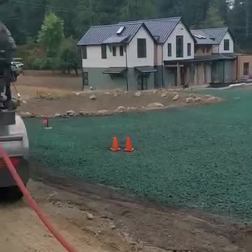 Hydroseed application on large residential property near forested area in Washington State.