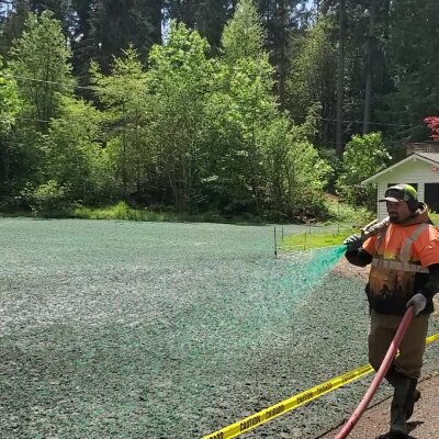 Worker hydroseeding lawn in Washington state.