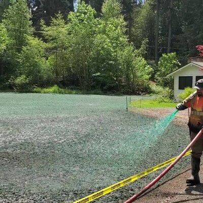 Worker hydroseeding lawn in Washington State.