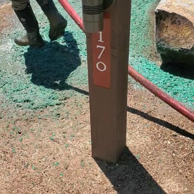 Worker applying hydroseed mixture on lawn in Washington State.