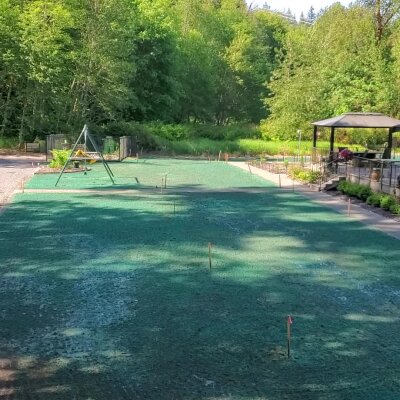 Newly hydroseeded lawn with playground and gazebo in Washington State.