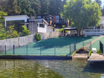 Waterfront residential lawn in Kirkland with fresh green hydroseeded grass near dock and fence.