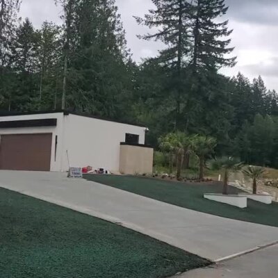 High-end front yard hydroseed lawn installation near new construction home.
