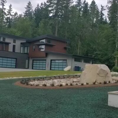 Hydroseeded front yard with decorative rocks at modern Redmond home.
